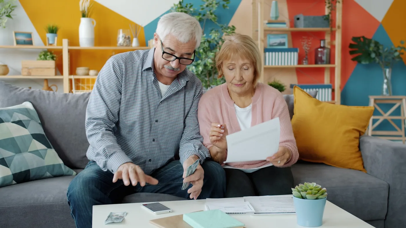 A retired couple reviewing their finances at home